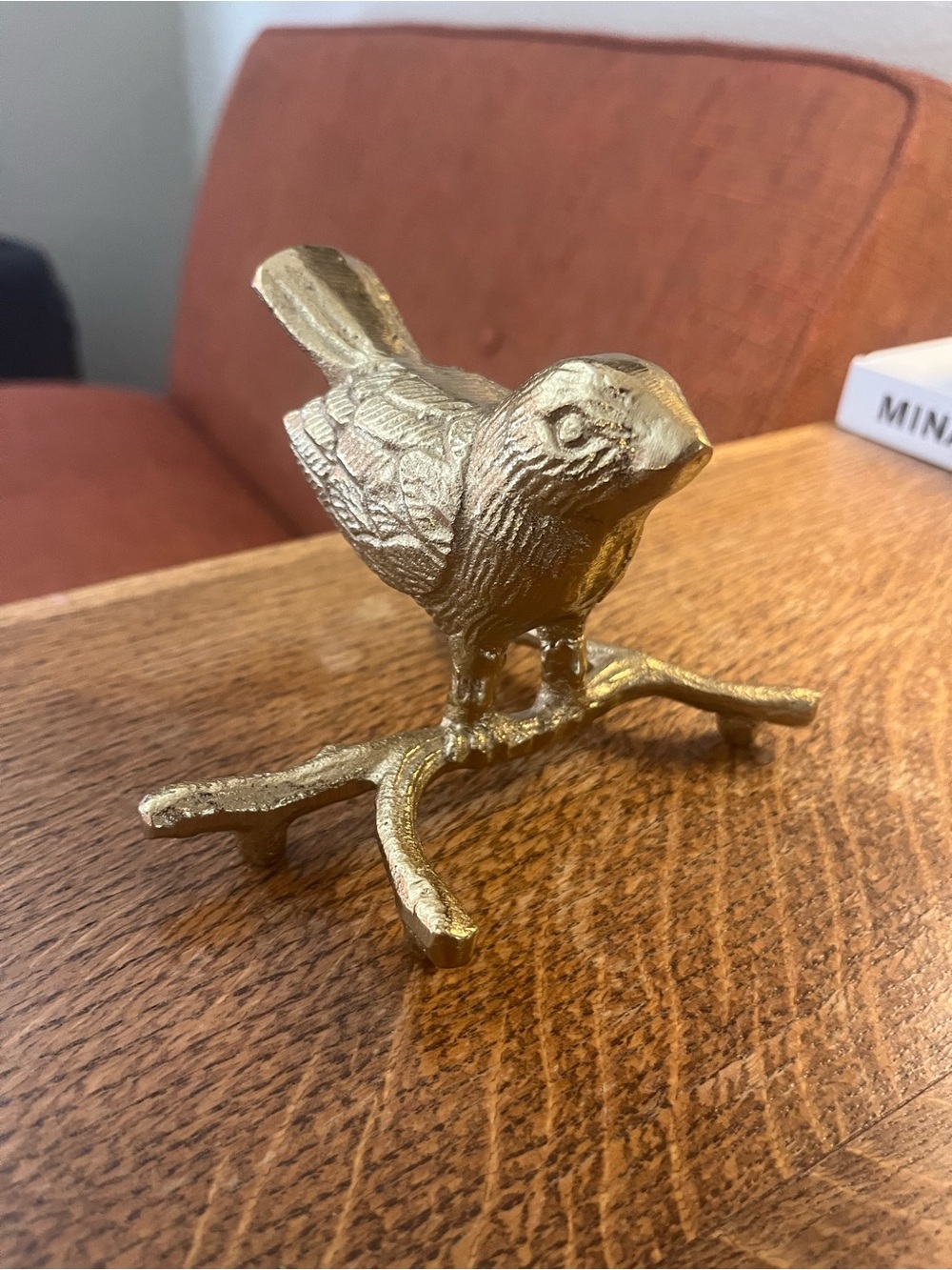 Creative Co-Op gold-finished cast aluminum bird on branch accent piece